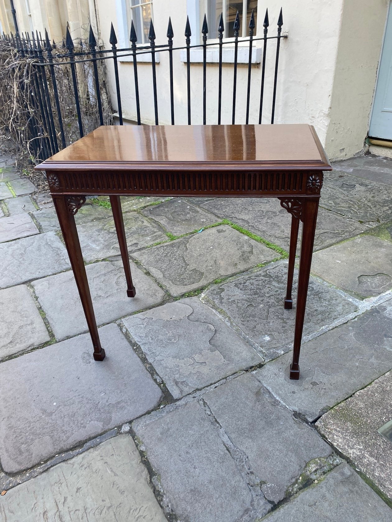 CHIPPENDALE STYLE RECTANGULAR MAHOGANY OCCASIONAL TABLE STANDING ON SQUARE TAPERING LEGS AND SPADE FEET