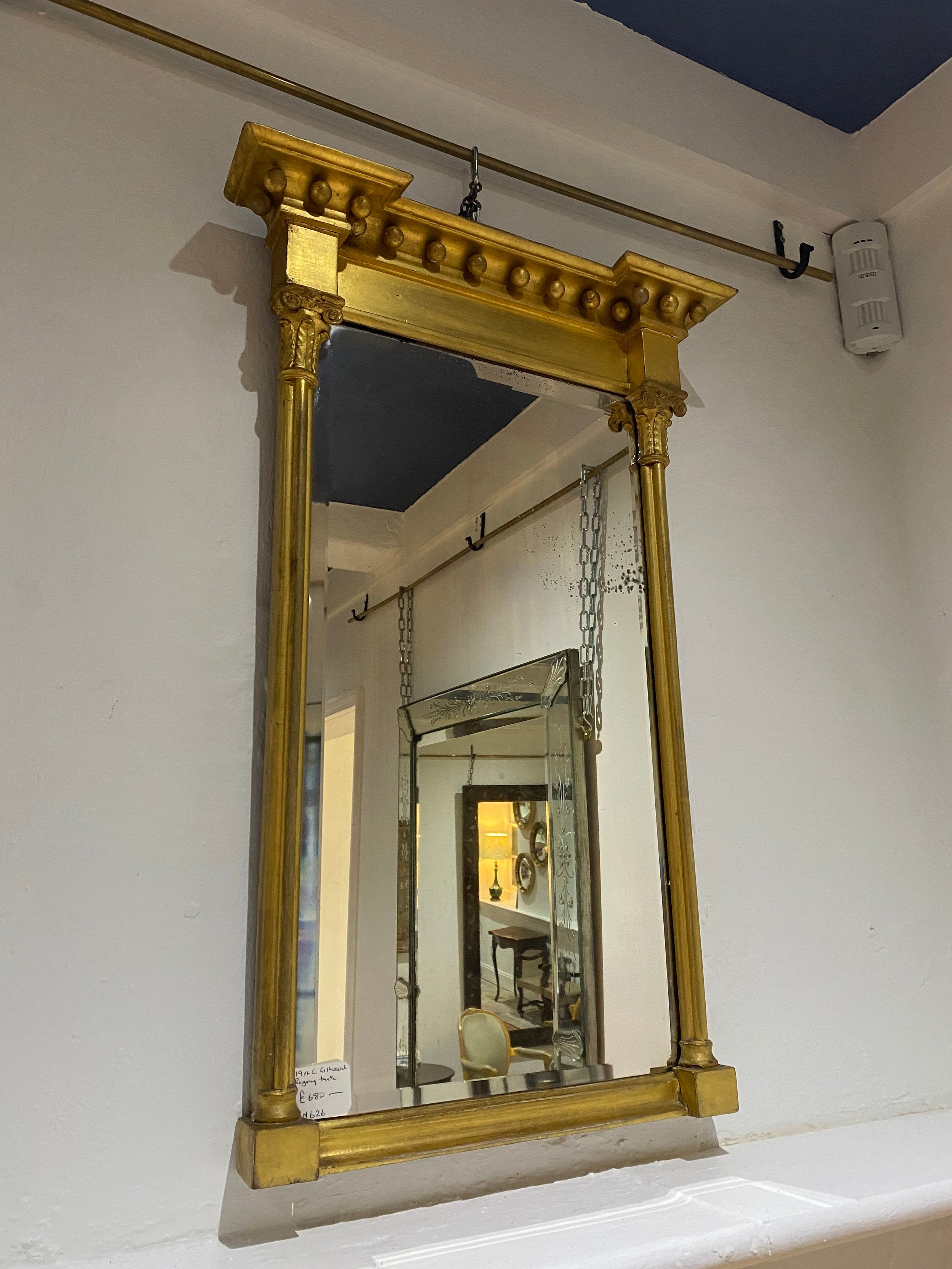 A 19TH CENTURY GILTWOOD WALL MIRROR IN THE REGENCY TASTE WITH ORIGINAL BEVELLED MIRROR