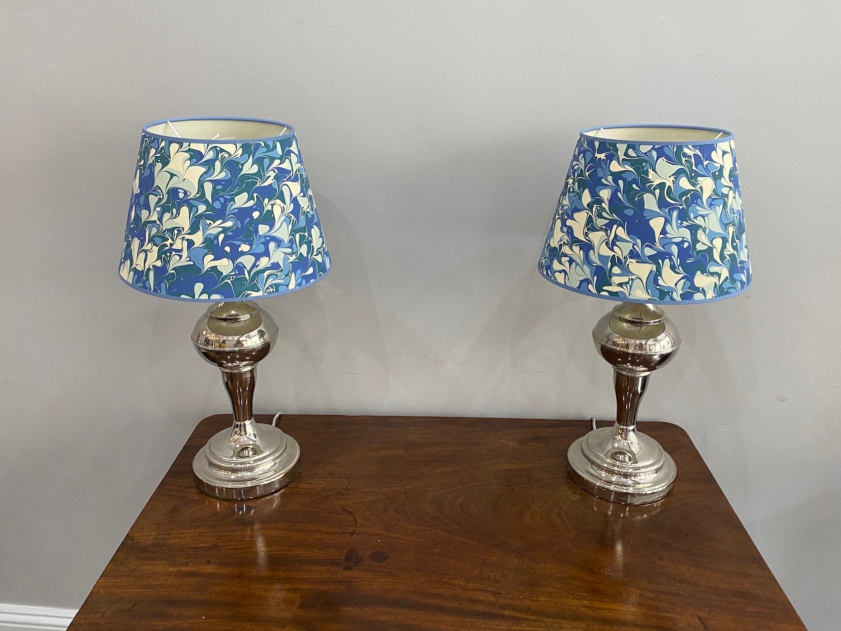 A PAIR OF EARLY 20TH CENTURY NICKEL PLATED LAMPS CIRCA 1920S