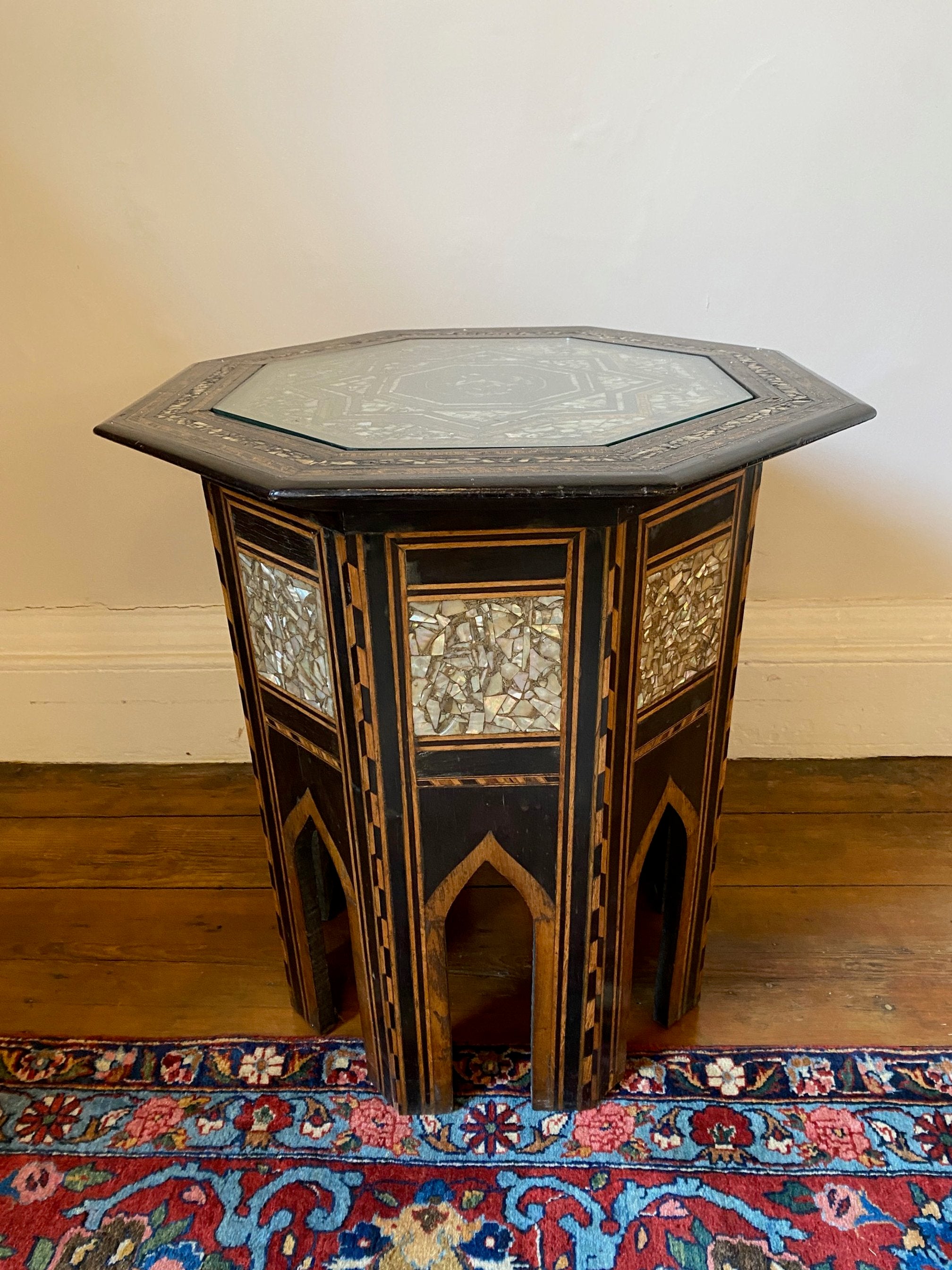 19TH CENTURY SYRIAN OCCASIONAL TABLE WITH EBONISED TIMBERS, MIXED INLAY AND MOTHER OF PEAR DECORATION. REMOVABLE GLASS TOP FITTED TO PROTECT THE TOP.