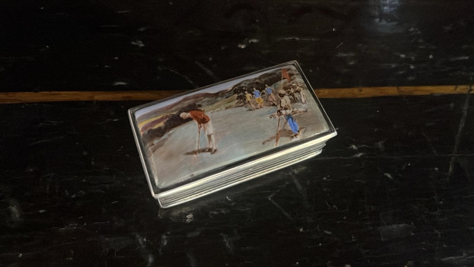 American silver and enamel pill box, this decorated with a scene of lady golfer putting, the caddy holding flag (BN297)